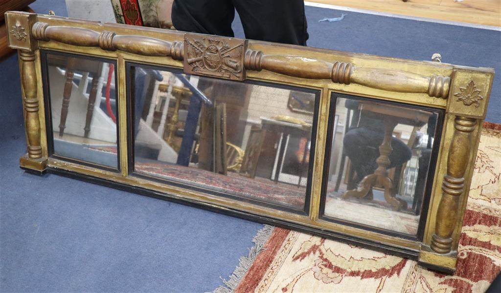 A Regency mahogany gilt-framed overmantel mirror centred by a military trophy, 160 x 60cm